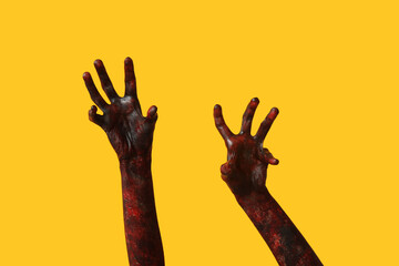 Hands of zombie on yellow background. Halloween celebration