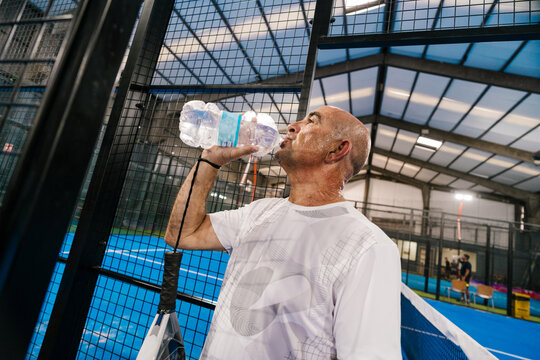 Padel player's hydration break