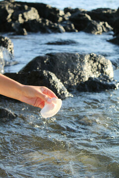 Woman in White Dress Gathering Shells