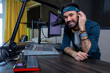 Man working in professional music studio with modern equipment broadcasting live show