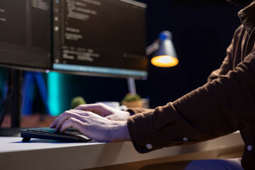 Computer scientist typing on keyboard, implementing security measures to protect company systems and data. IT specialist writing, testing and debugging Java code for software applications, close up