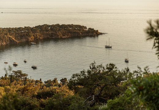 Scenic View of Sailboat and Rocky Coastline

