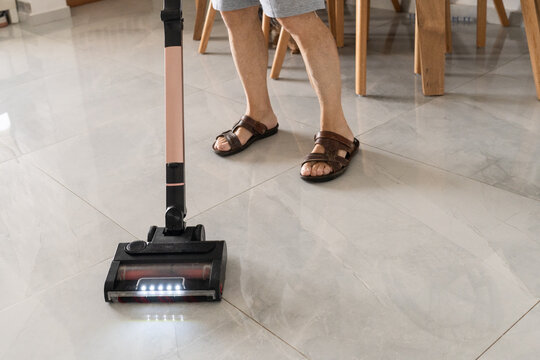 Cordless Vacuum Cleaner On Shiny Tiled Floor