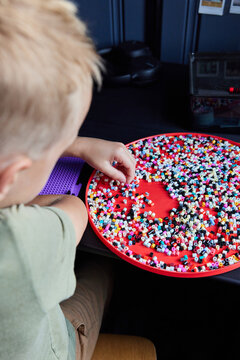 Little boy doing perler beads