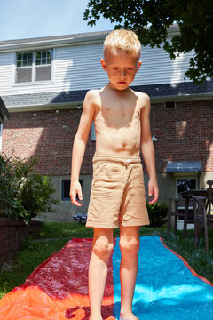Little boy using waterslide