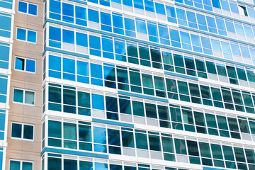 Fototapeta premium Building background. Glass building window. Architectural detail. Background of architecture. Modern glass background. Glass facade background. Architecture. Building architecture. Glass window