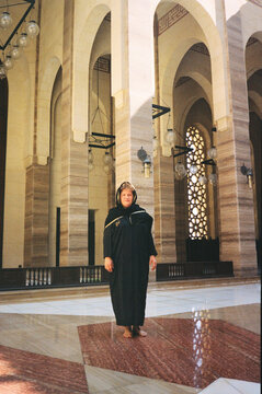 Woman in Traditional Black Abaya in Majestic Mosque Hall