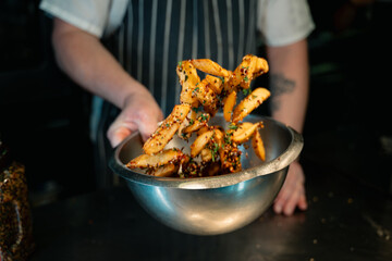Chips Fries Being Tossed with Seasoning with motion blur