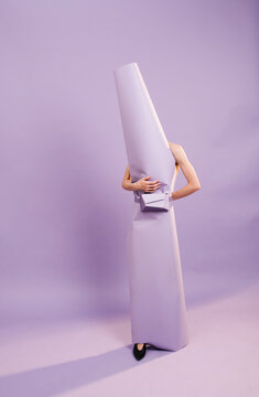 Creative Fashion Concept With Person Wrapped In Purple Paper