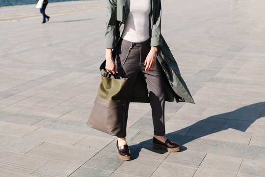 Stylish Woman Holding Bag While Walking Outdoors