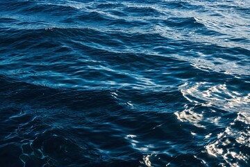 Fototapeta premium A surfer rides a wave in the middle of the ocean, great for adventure and travel themes