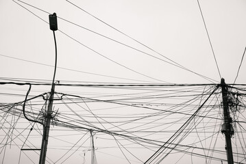 Tangle of Overhead Wires on Utility Poles