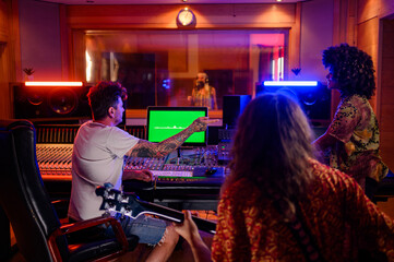 Diverse musicians and producer making music at recording studio.