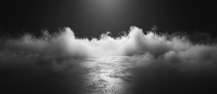 White smoke or fog spreads across the floor creating a thick mist in a dimly lit room against a black backdrop Smoke effects in a studio setting