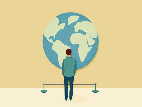 Person watching large world globe in exhibition