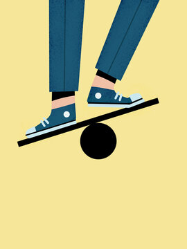 Faceless man balancing on ball