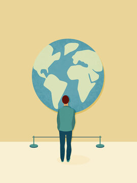 Man watching large world map globe in exhibition