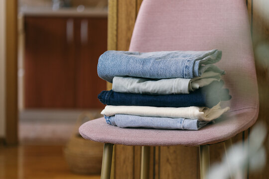 A pile of clothes on a chair