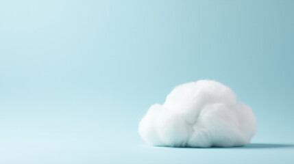 a fluffy white cloud-shaped cushion against an isolated soft baby blue background