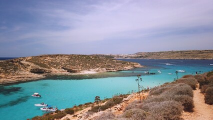 Comino, Malta 29.05.2024 - Boats anchored near Blue lagoon, Cominotto island in the back. Revealing...