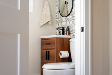 Stylish small bathroom with wallpaper accent wall