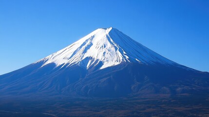 Close-up of Mount Fuji snowy peak against a clear blue sky, highlighting the mountain majestic and imposing presence