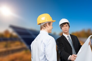 The solar farm with two engineers check the operation