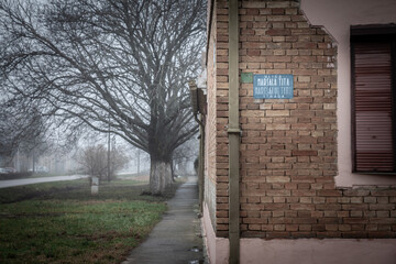 Selective blur on Bilingual street sign Ulica Marsala Tita in Serbian & Maresalul tito strada in...