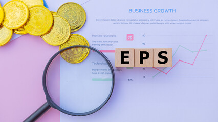 Wooden cube with the word EPS. It is an abbreviation of Earnings Per Share. Business profitability...