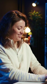Vertical video Joyous woman doing software quality assurance celebrating after reading source code and finding no errors. Cheerful engineer excited after inspecting coding on desktop PC, seeing no