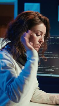Vertical video Teleworking computer technician typing on keyboard, implementing security measures to protect company systems and data, close up. Remote IT employee at home debugging code for software