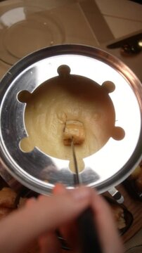 POV Shot of Fondue Fork with Bread Dipping into Cheese Vertical Video