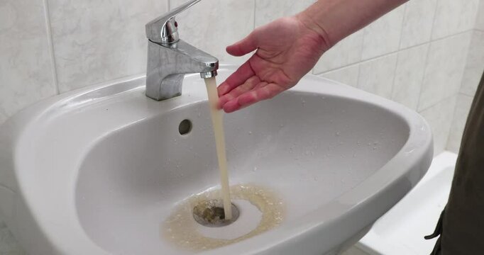 Contaminated dirty tap water flowing