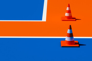 Traffic cones on blue and orange floor