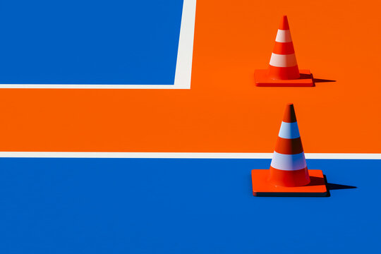 Traffic cones on blue and orange floor