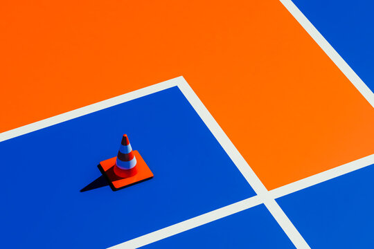 Traffic cone on blue and orange surface