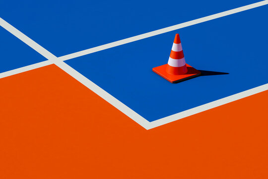 Traffic cone on blue and orange surface