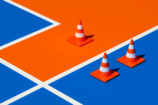 Traffic cones on blue and orange ground