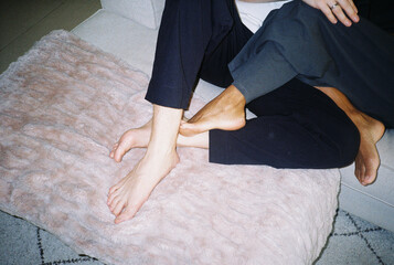 Anonymous couple resting on the couch.