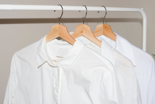 White shirts hanging on a rail