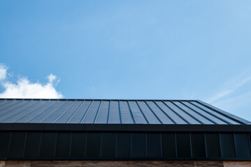 Close up of roof with blue sky.
