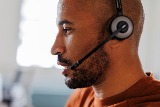 Focused customer service representative working on computer