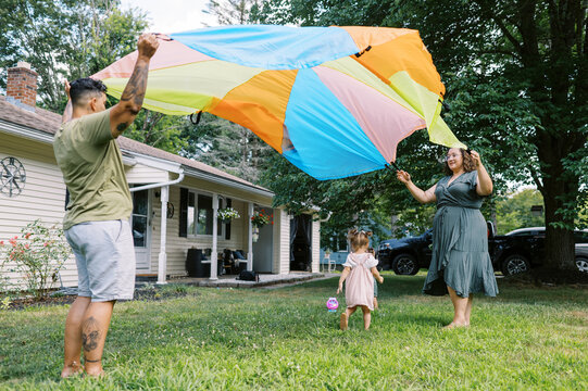 playful happy lgbtq family with mothers and toddler daughters