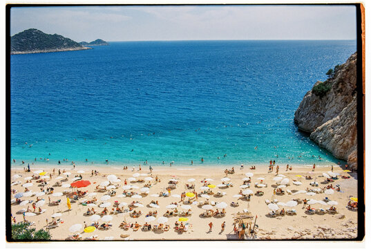 Film photo of crowded beach in summer, vacation at the seaside aerial - Powered by Adobe
