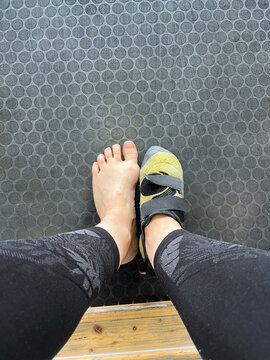 POV UGC of one Barefoot and One Foot in Rock Climbing Shoes