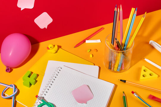 Colorful Pencils, Numbers, Notebooks and Stickers on Orange Backdrop. 