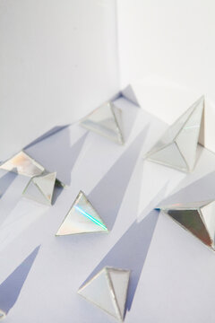 Shiny and reflective triangles and crystals in a white background