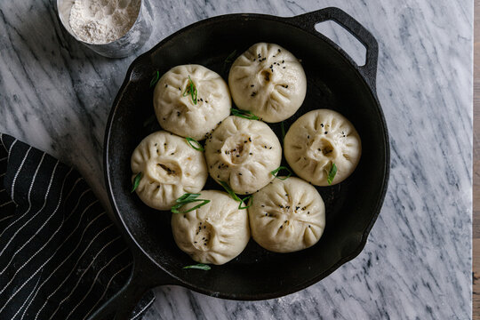 Pan fried steam buns in a pan