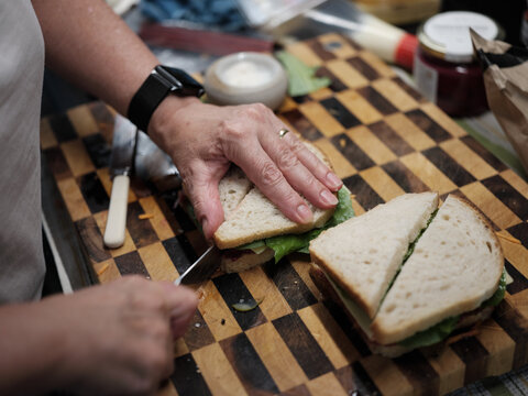 Person Making a Sandwich on a Cutting Board