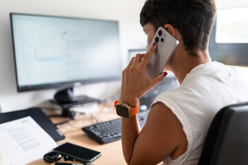 Businesswoman using smartphone and working at home